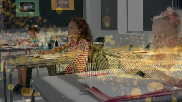 Girl turning pages while kids writing in books, golden overlay drifting across desks for study