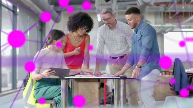 Lead tapping tablet and pointing at design plans leading team moving papers under growing pink net