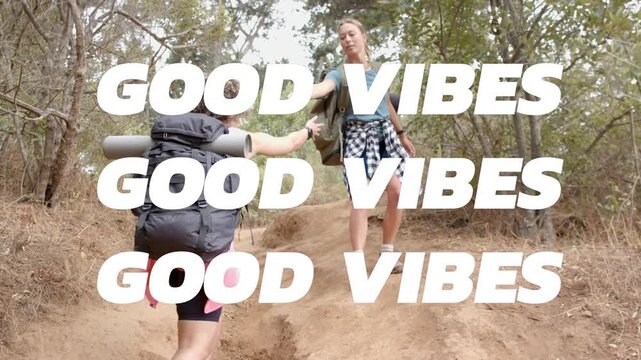 Two women hiking path friend extending hand climber pulling pack up GOOD VIBES glitching over frame