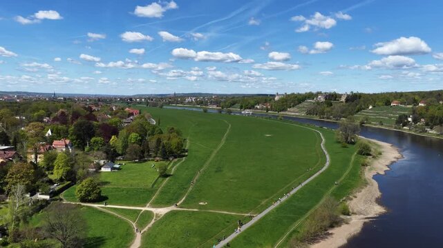 Aerial panorama of the Dresden Elbe meadows featuring the three Elbe castles on the hillside, the river, and vast green spaces under a blue cloudy sky. Lingner schloss Eckberg albrechtsberg