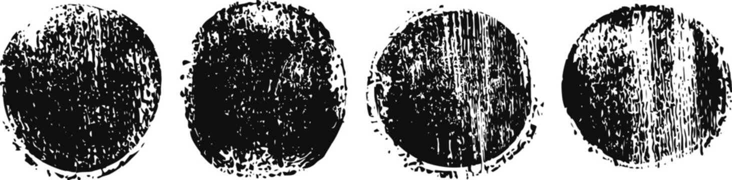 four black textured paint smudges with rough circular and square shapes on white background