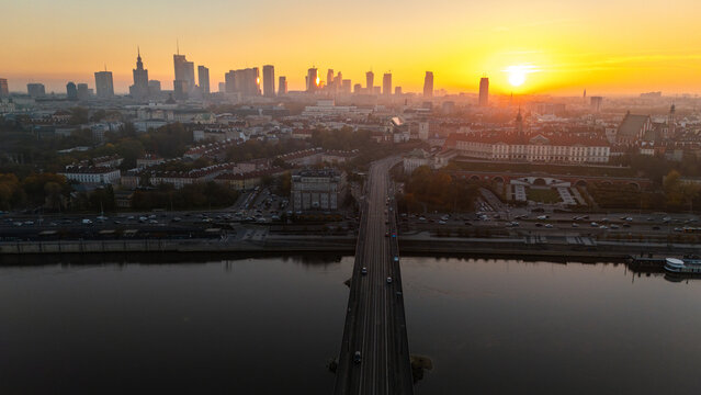 An aerial view of the Vistula River overlooking Warsaw's Old Town in Poland during the autumn sunset