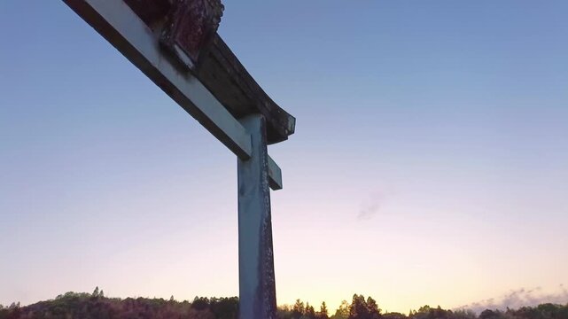 Torii gate silhouette at sunset with wide sky copy space
