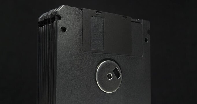 Black floppy diskettes. Floppy disk, diskette, or floppy diskette - type of disk storage made from a thin, flexible disk coated with magnetic storage medium. Cinema 4K 60fps zoom-out video