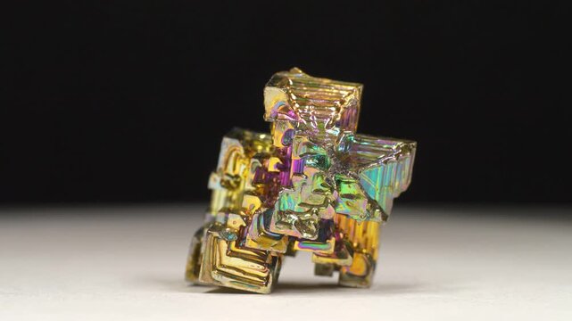 Bismuth crystals. Bismuth - chemical element with symbol Bi and atomic number 83. Post-transition metal and one of pnictogens. Synthesized bismuth crystal. Iridescent coloration is due to oxide film