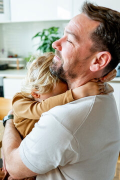 Father hugging little boy, lovely family moment.