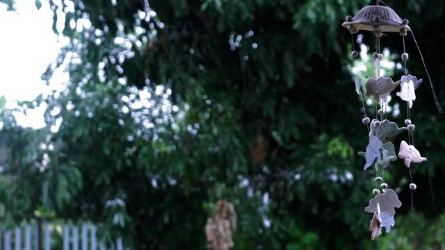 Rainy Season Ambiance: Raindrops dripping from Roof, Water on Pavement and Green Grass Details, Terracotta Wind Chime and Satellite Dish in Monsoon Weather.