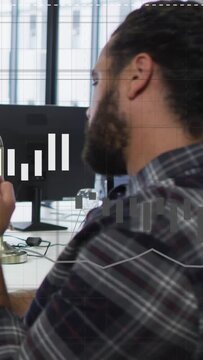 Vertical video: Man raising smartphone, checking stocks while animated charts rising across screen