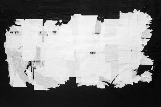 Old torn city poster on a black wall