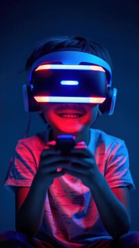 A young child is seen wearing a virtual reality headset with pink and blue lights. They are smiling and appear to be engaged in playing a video game using handheld controllers.