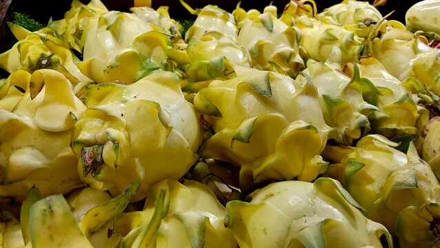 Fresh produce of yellow vegetables on display at market stall indoors