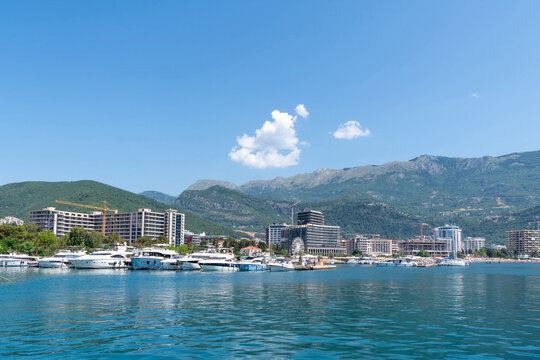 View into land of high rise buildings and yachts moored in the harbour, Budva, Montenegro