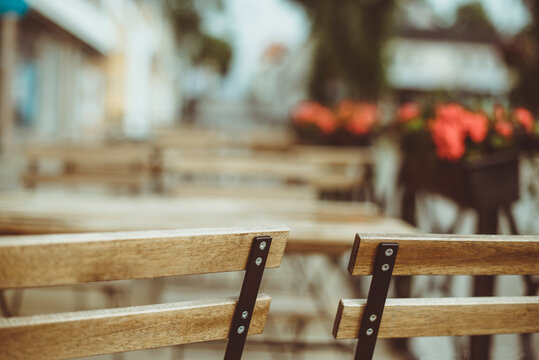 Close-up of wooden chairs and tables in a city street, Sweden