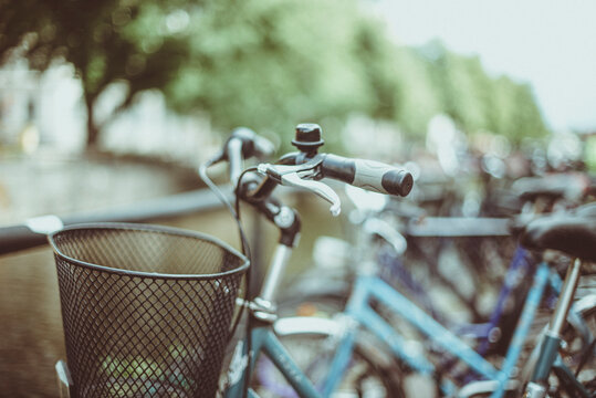 Close-up of a metal basket on the front of a bicycle parked alongside a row of bicycles, Sweden