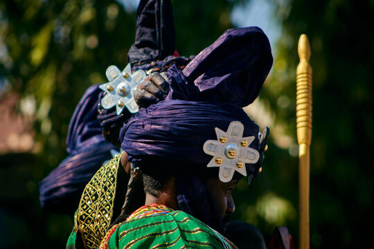 Zaria city, Nigeria - 21 March 2026: View of a figure in a deep blue turban with gleaming silver stars, contrasting vibrant green and gold traditional attire.