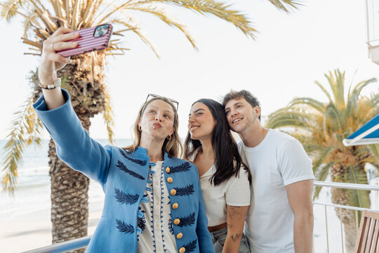 Friends taking selfie on vacation balcony