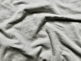 wrinkled light gray fabric texture closeup soft folds subtle shadows abstract minimalist background © Arthur