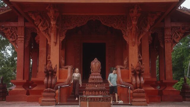 Tourists in Red Temple Wat Sila Ngu on Koh Samui, Thailand. Architecture with Buddhist design