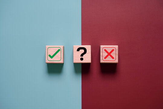 Approve or reject decision concept with check mark, question mark, and cross icons on wooden blocks, representing evaluation, choice, uncertainty, risk assessment, and business decision making process