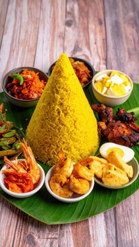 Tumpeng nasi kuning traditional indonesian cone-shaped yellow rice served with assorted side dishes, celebration, cultural heritage, authentic culinary