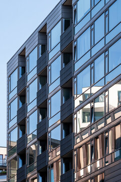Modern urban apartment building exterior with repeating windows on a clean facade showing strong geometry pattern in contemporary architecture