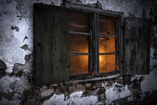 Old decayed wooden window on old house facade in candlelight, Mindelheim, Unterallg&auml;u, Bavaria, Germany