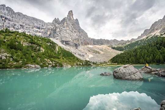 Turquoise green Sorapis lake, Lago di Sorapis with reflection and mountain top Dito di Dio, Dolomites, Belluno, Italy