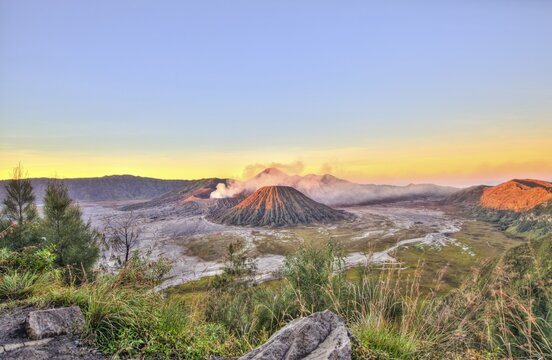 Sunrise, smoking volcano Mount Bromo, Mt. Batok at front, Mt. Kursi at back, Mt. Gunung Semeru, Bromo Tengger Semeru National Park, Java, Indonesia
