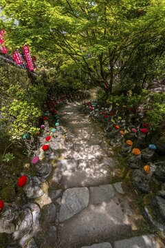 Buddha statue with colorful caps, Daisho-in temple complex, on Itsukushima Island, Miyajima, Hiroshima Bay, Japan