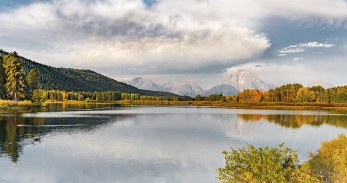 Mount Moran reflected in Snake River, morning mood at Oxbow Bend, autumn trees and Grand Teton Range, Grand Teton National Park, Wyoming, USA