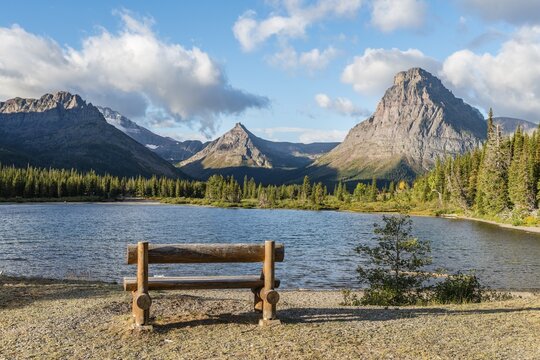 Viewing bench at the mountain lake, Two Medicine Lake, mountain landscape, Sinopah Mountain, Glacier National Park, Montana, USA