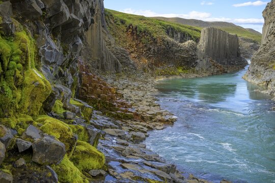 Basalt columns coloured orange by iron oxide, Stu&eth;lagil Canyon, Egilssta&eth;ir, Austurland, Iceland