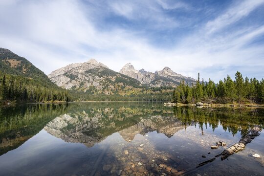 Reflection in Taggart Lake, view of the Teton Range, peaks Grand Teton and Teewinot Mountain, Grand Teton National Park, Wyoming, USA