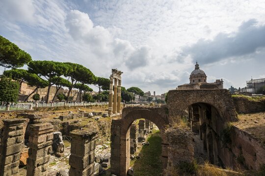 Temple of Castor and Pollux, 484 BC, Corinthian columns, in front of the ruins of the Church Santa Maria Antiqua and the Temple of Augustus, Roman Forum, Rome, Lazio, Italy