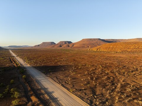 Aerial view, road leading through dry desert landscape, hills in Damaraland, Namibia