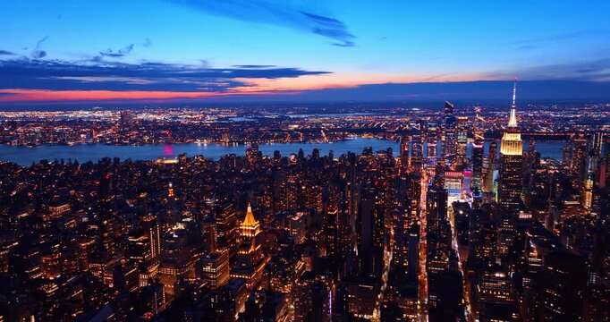 Iconic panorama of Manhattan from drone. Night scenery of New York City with sparkling lights.