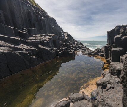 Water gathering between rocks, Roman Bath, Hexagonal basalt column by the Sea, Blackhead, Dunedin, Otago, South Island, New Zealand