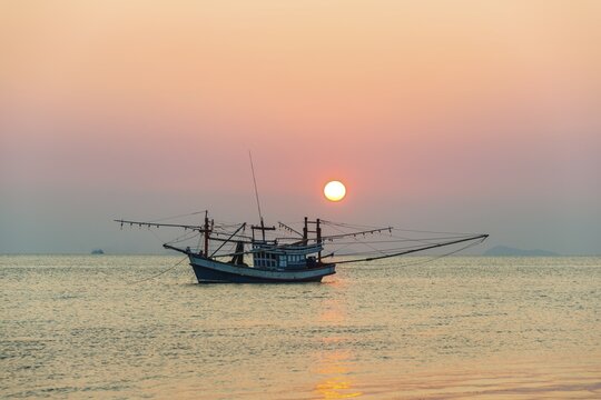 Boat in the sea at sunset, in front of small islands, Koh Samui, Gulf of Thailand, Thailand