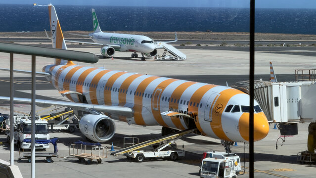 April 9th, 2026, Fuertaventura, Spain. Passenger airplane at gate with ground service vehicles travel aviation concept