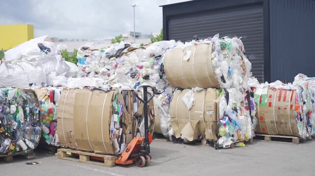 Baled recycled materials at a waste sorting facility in an industrial area for environmental and recycling content usage