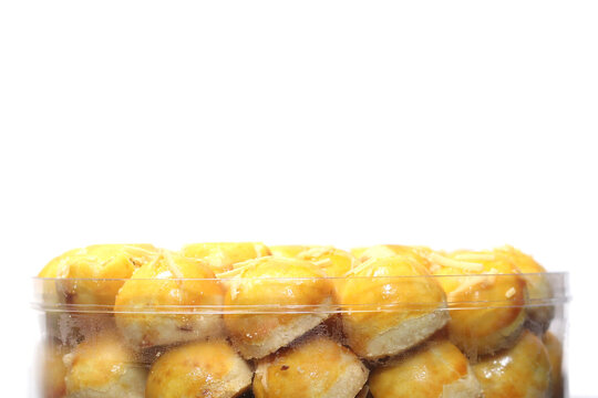 a transparent container filled with Nastar cookies against a clean white background.
