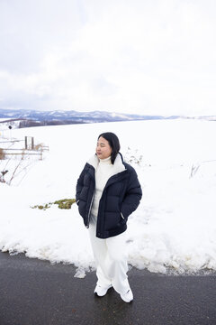 Portrait Beautiful asian fat woman smile happy travel and enjoy with snow winter season. Wearing thick coat, Snowy landscape surrounds, Joyful winter moment, perfect for family scenes. Vacation