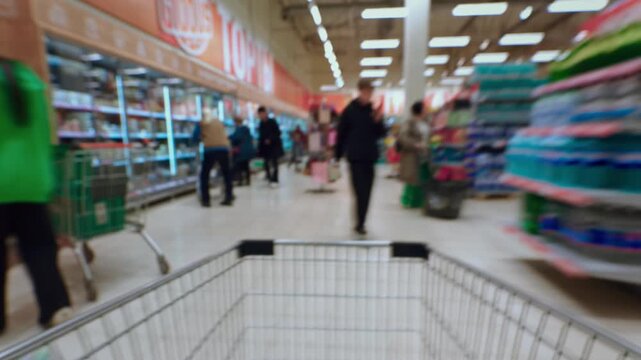 Walk through supermarket with an empty shopping cart. Customer makes purchases, spends money. Black Friday or discount season. Timelapse. Grocery store and sections with goods.