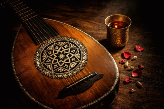 Vintage oud instrument with mother of pearl rosette and hammered brass tea glass with cardamom and rose petals nostalgic Middle Eastern still life for Heritage Month cultural heritage identity