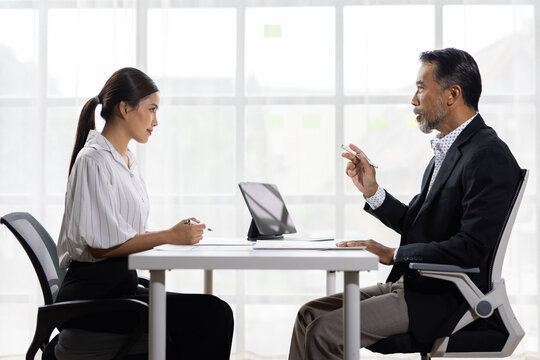 Asian businessman interviewing candidate for business position.