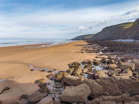Early morning low tide on a sand and rocky Cornwall beach