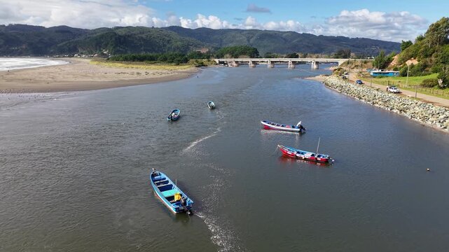Artisanal fishing boats at the mouth of Rio Lingue in Mehuin, Chile.