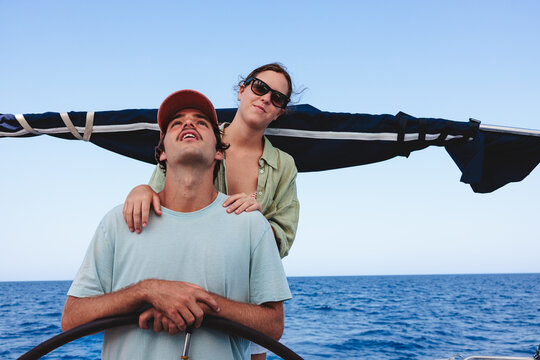 Couple sailing vacation enjoying summer ocean adventure