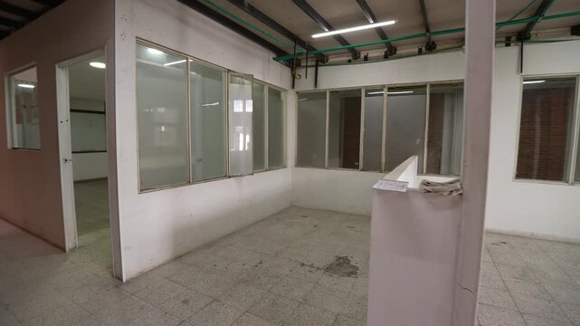 Empty industrial warehouse interior with brick walls and safety marking floor