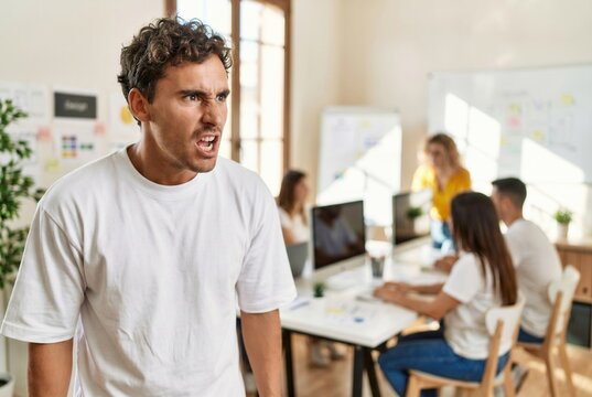 Man shouting showing aggression and conflict during an office meeting with coworkers